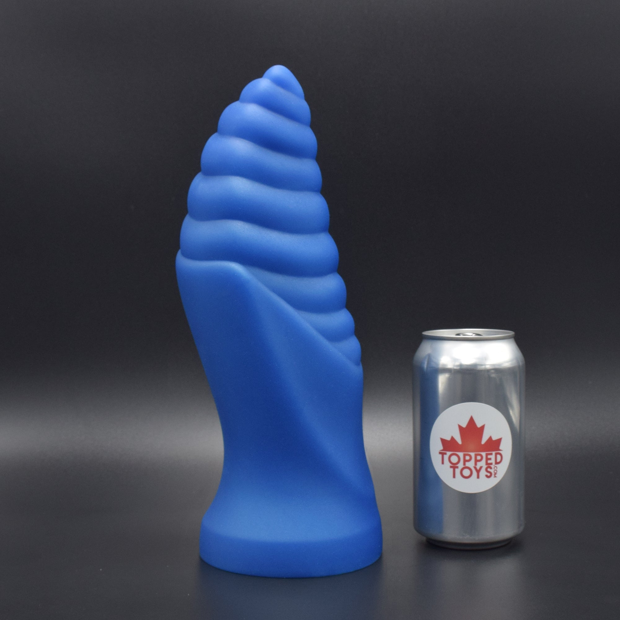 Cetos 100 in Blue Steel facing right, next to pop can with Topped Toys Logo