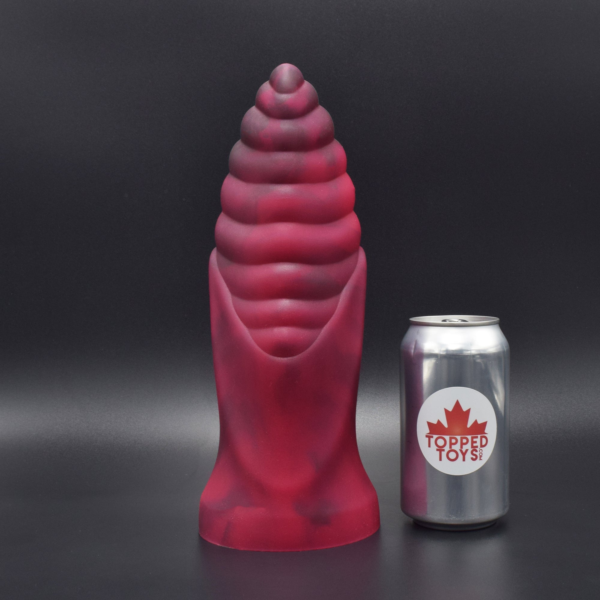 Cetos 110 in Forge Red facing forwards, next to pop can with Topped Toys logo