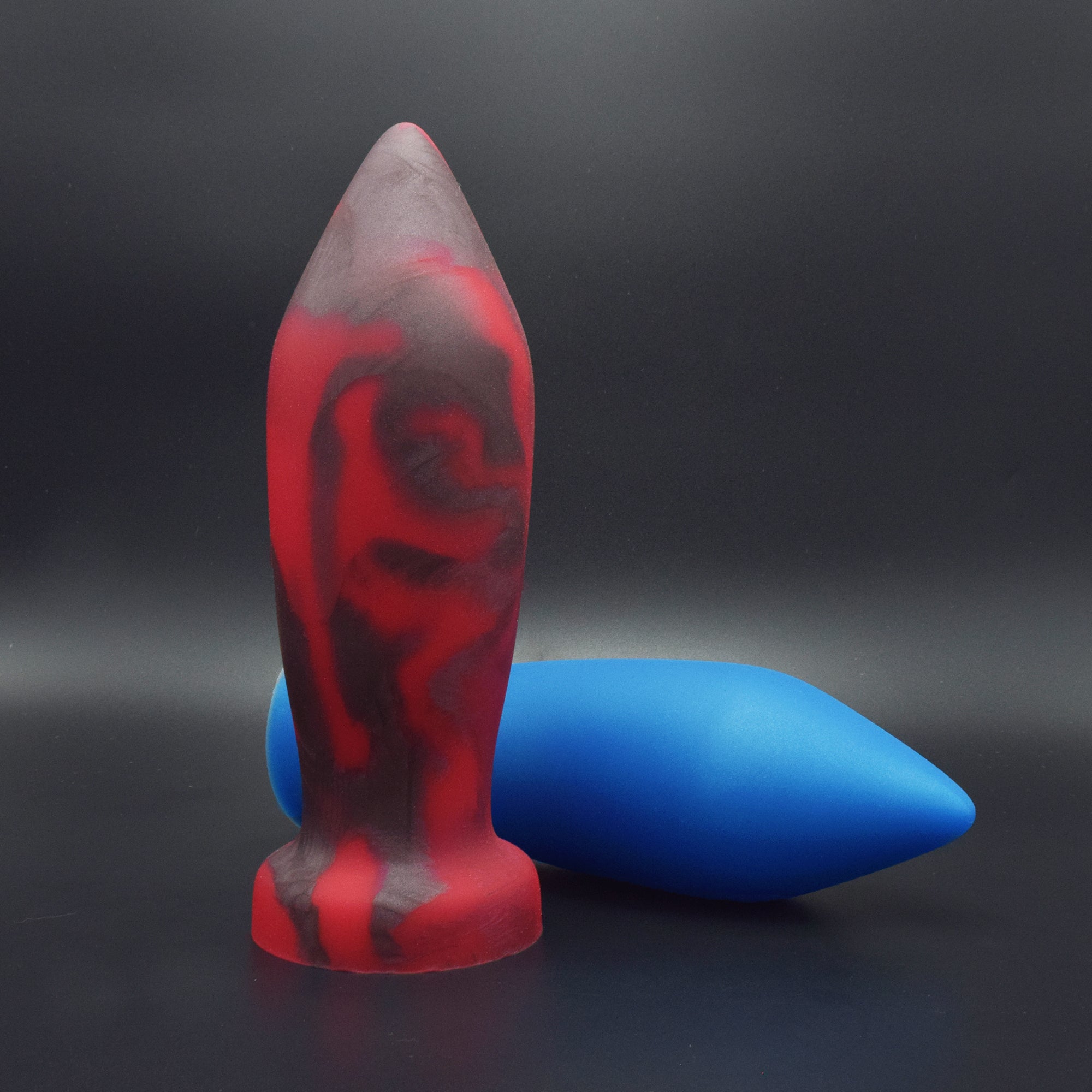 Deep Space 100 in Forge Red standing up, and Deep Space 100 in Blue Steel laying on its side