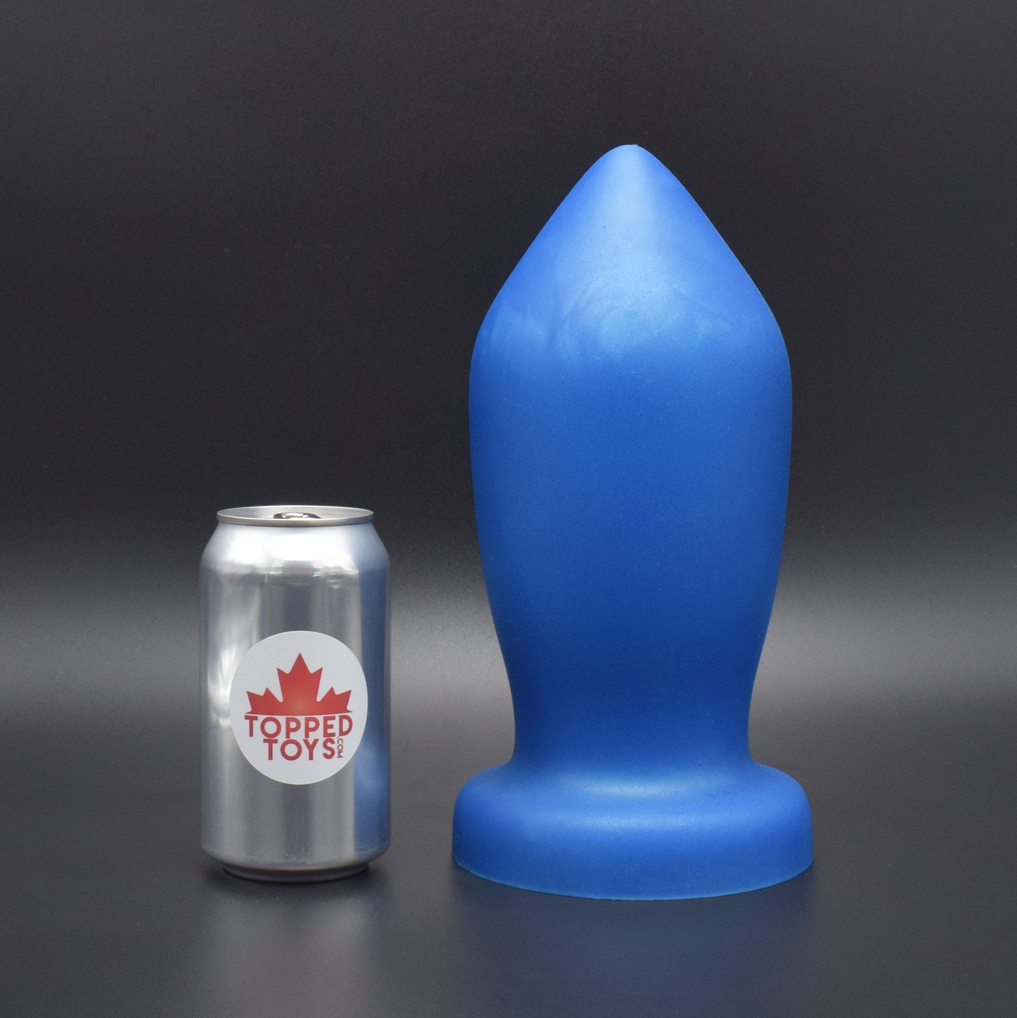 Deep Space 140 in Blue Steel standing up, next to pop can with Topped Toys logo