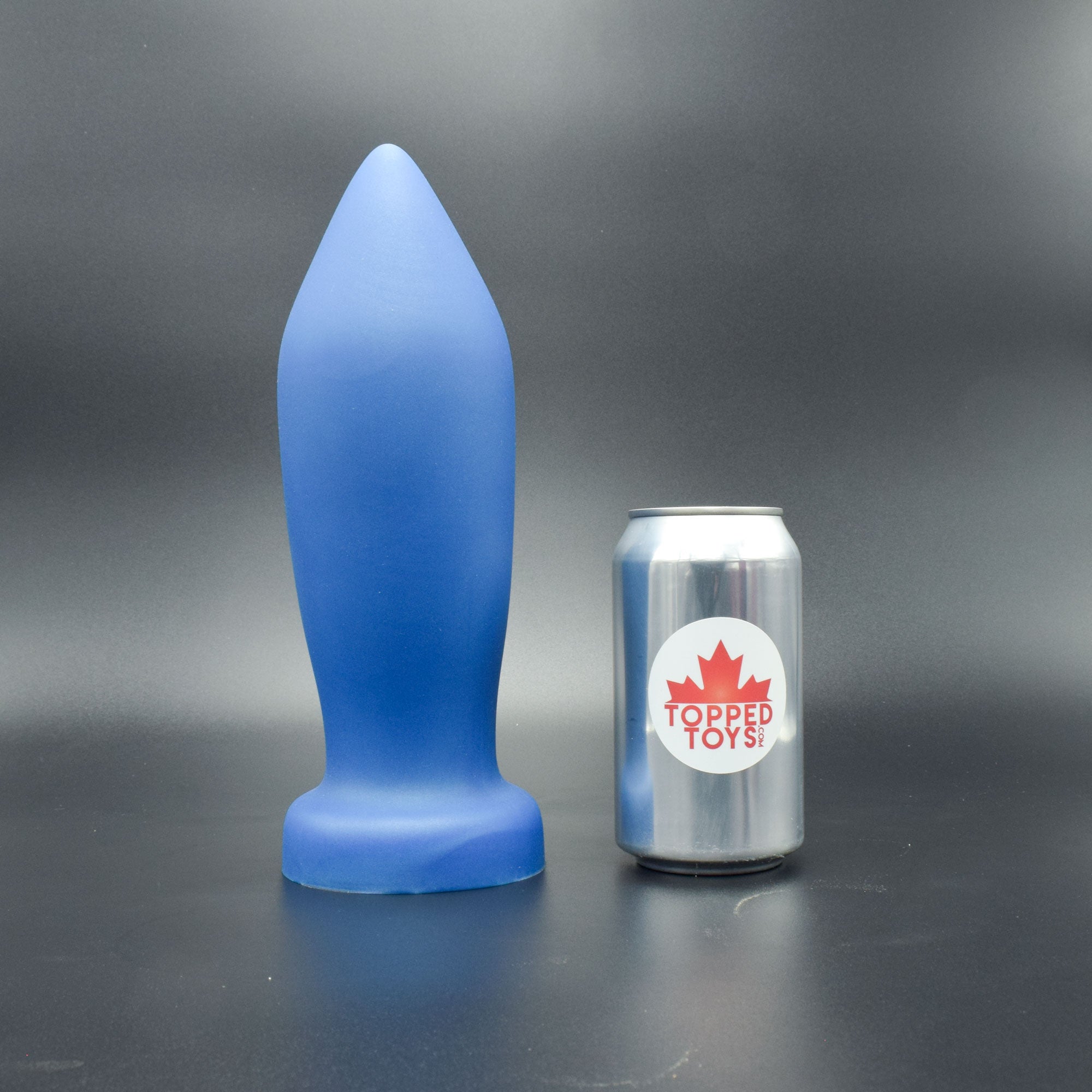Deep Space 100 in Blue Steel standing up, next to pop can with Topped Toys logo