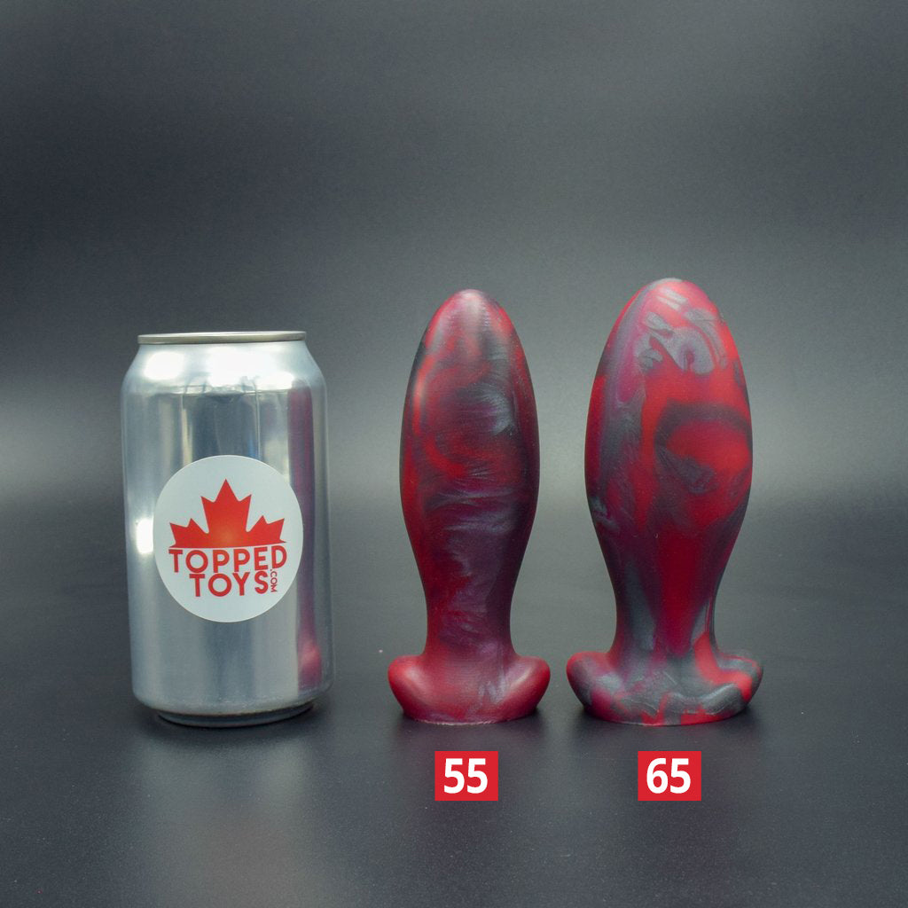 Gape Keeper 55 and Gape Keeper 65 in Forge Red, next to pop can with Topped Toys logo