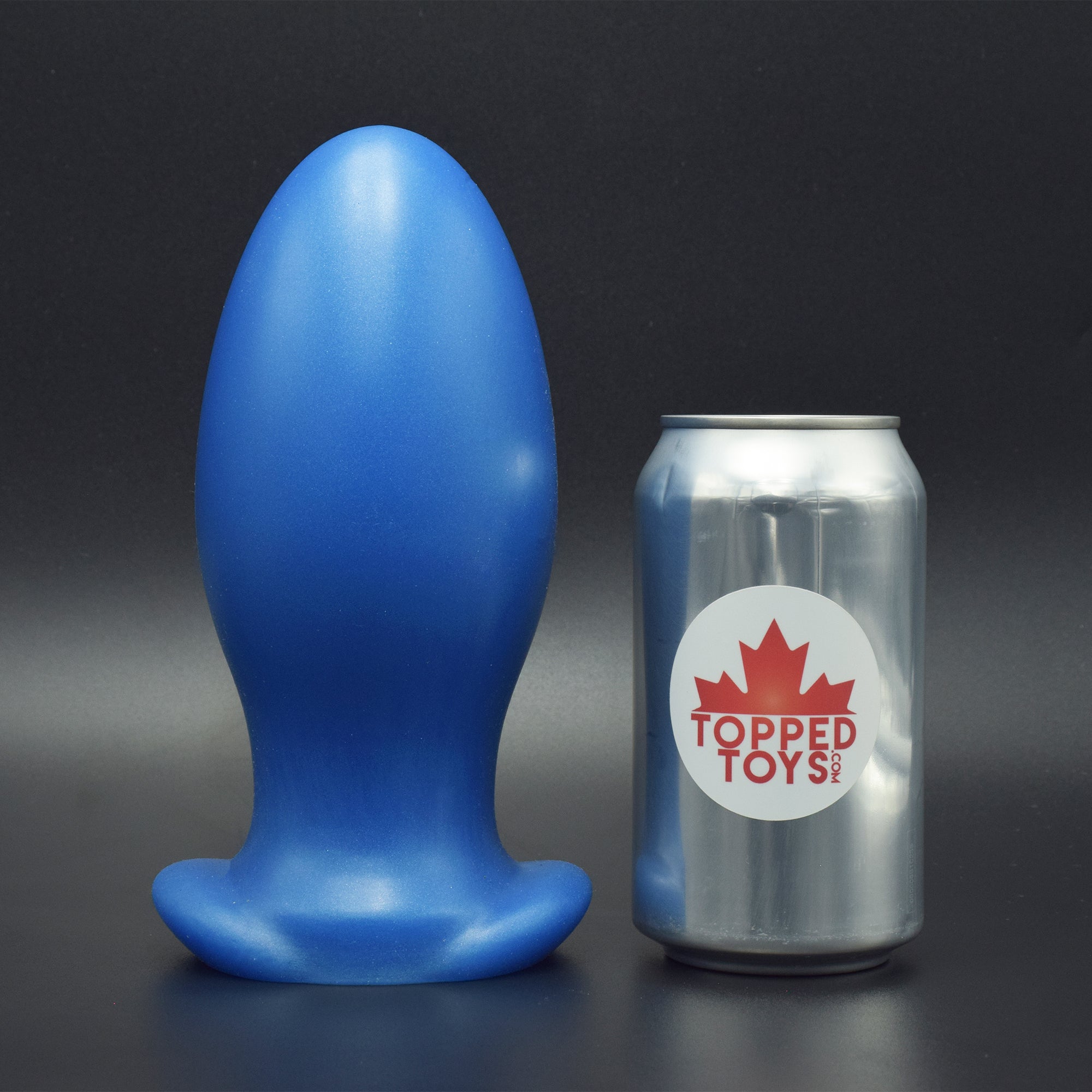 Gape Keeper 100 in Blue Steel standing up, next to pop can with Topped Toys logo