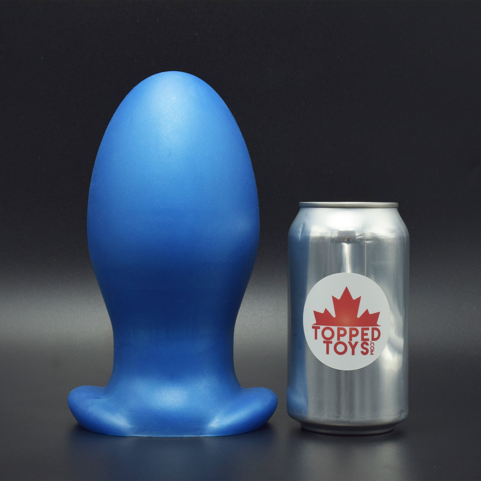 Gape Keeper 116 in Blue Steel standing up, next to pop can with Topped Toys logo