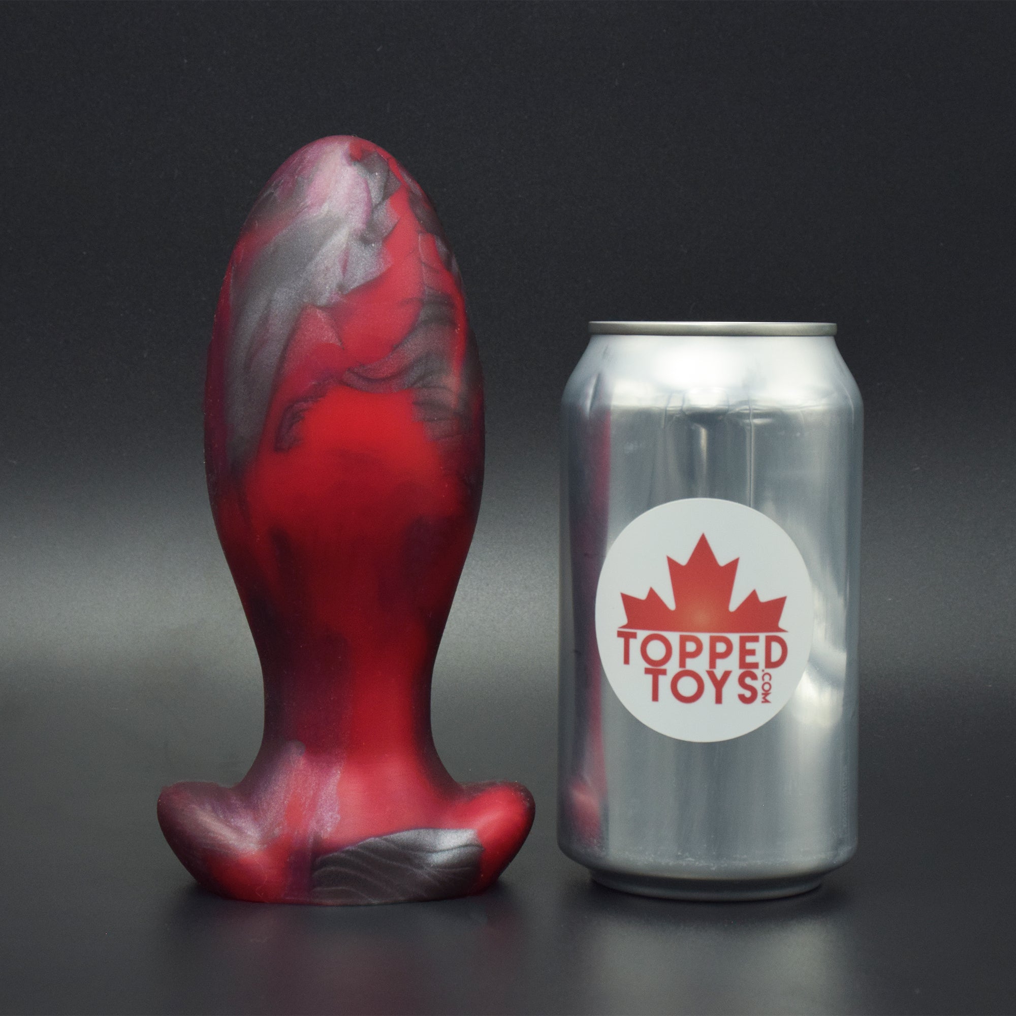 Gape Keeper 75 in Forge Red, next to pop can with Topped Toys logo