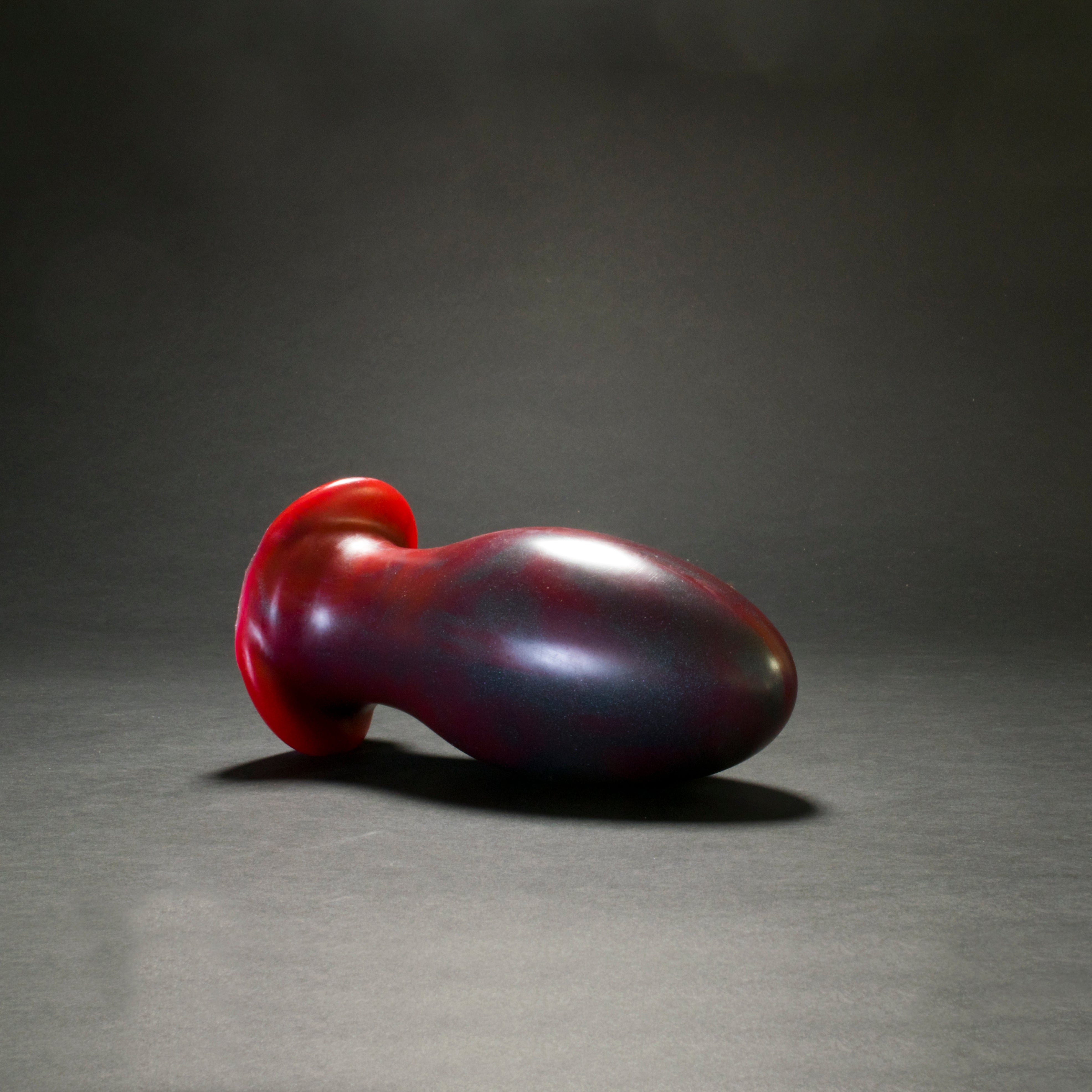 Gape Keeper 100 in Forge Red laying on its side