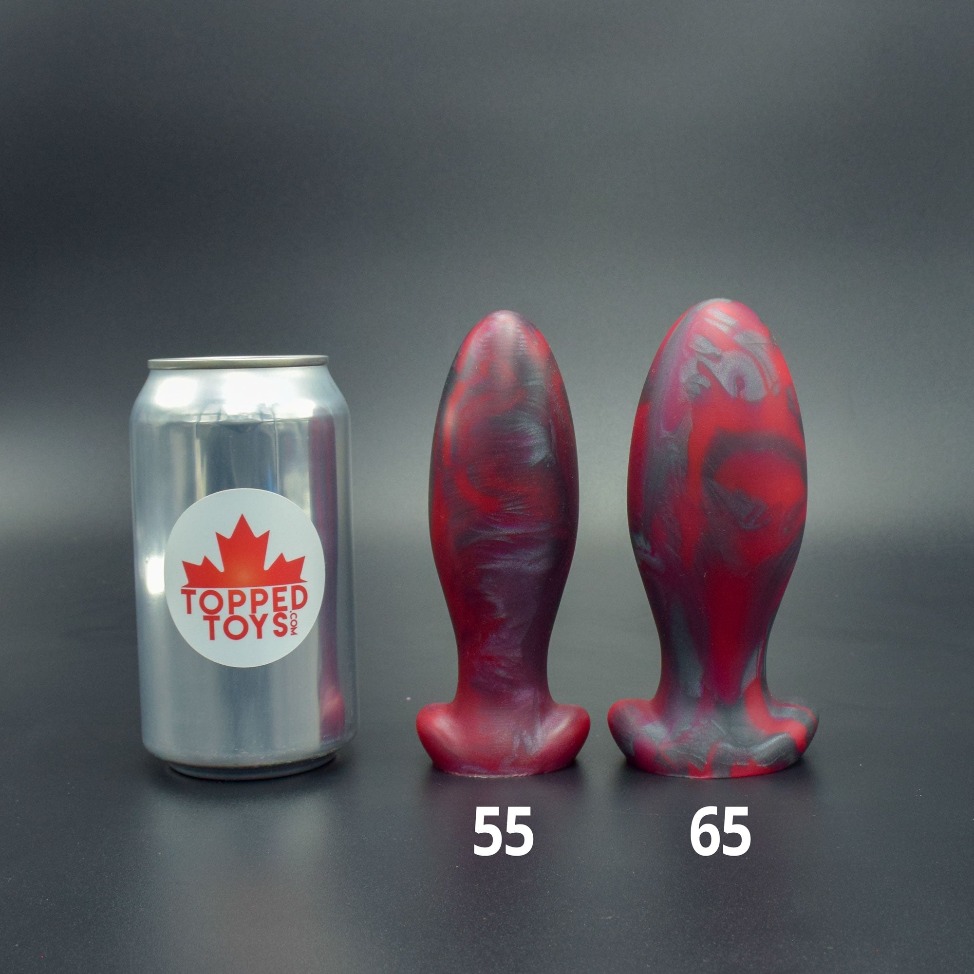 Gape Keeper 55 and Gape Keeper 65 in Forge Red, next to pop can with Topped Toys logo