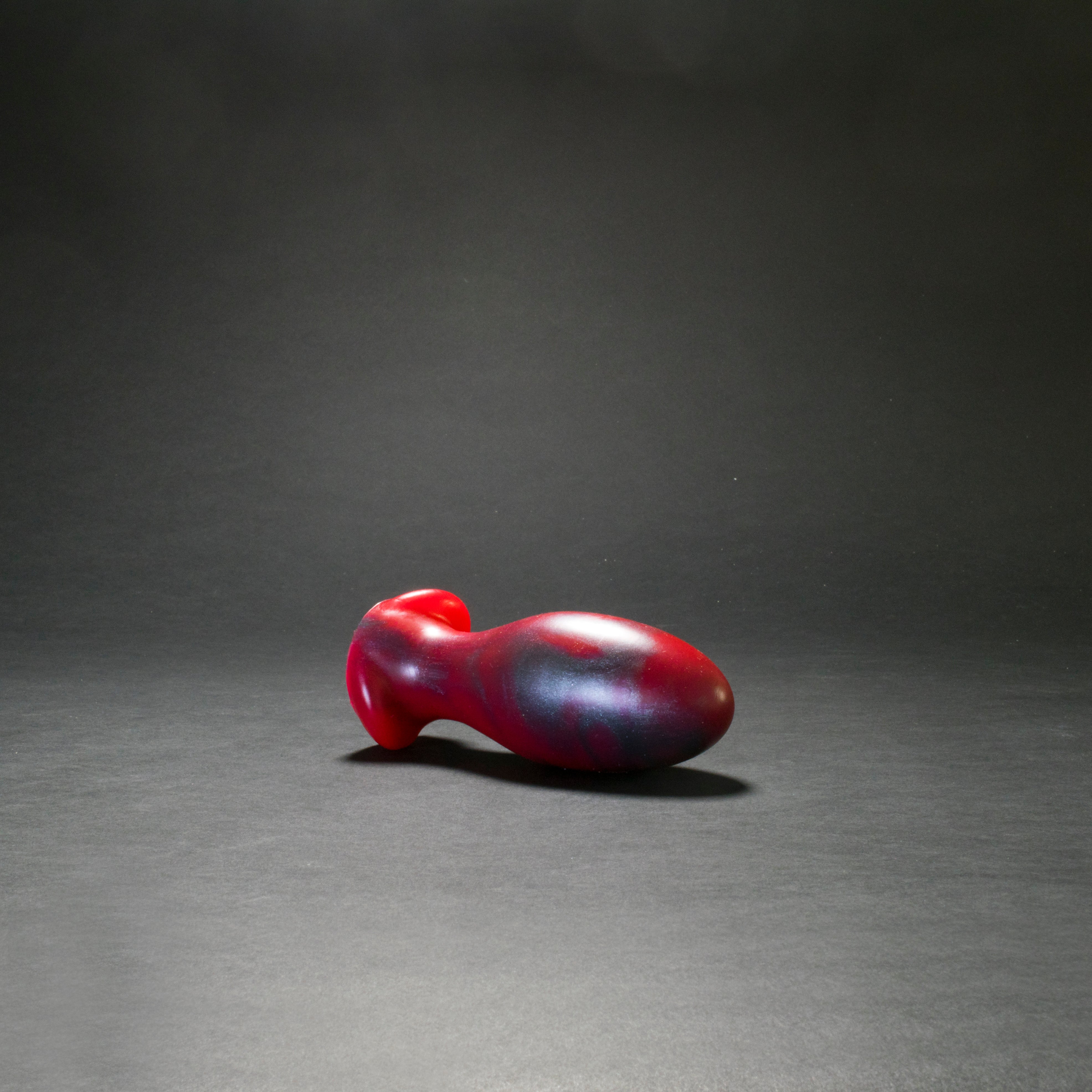 Gape Keeper 65 in Forge Red laying on its side