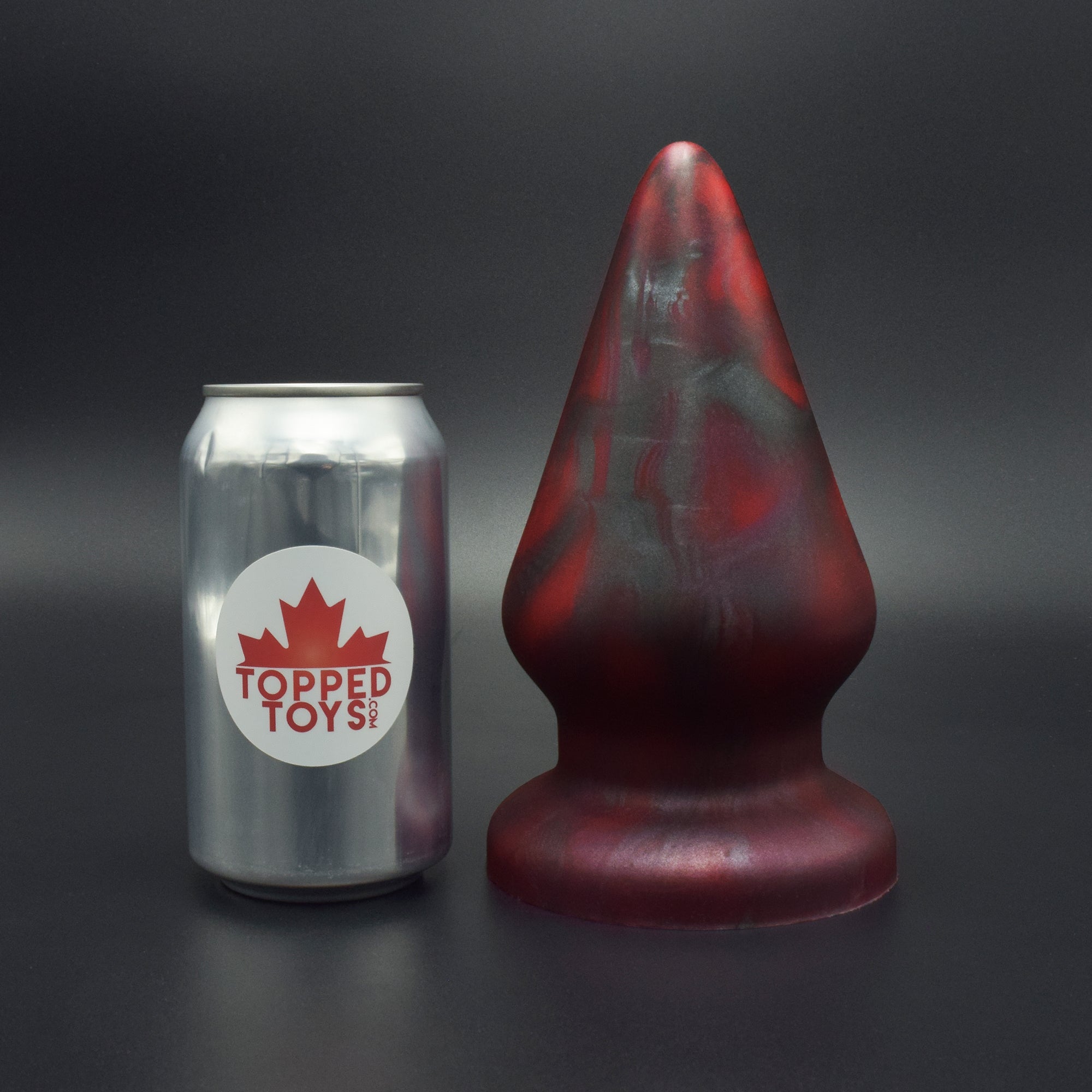 Grip 115 in Forge Red, next to pop can with Topped Toys logo