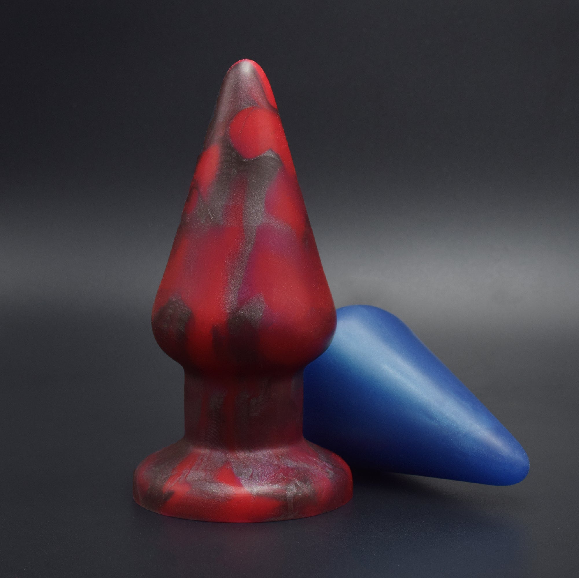 Grip 80 in Forge Red standing, and Grip 80 in Blue Steel laying on its side