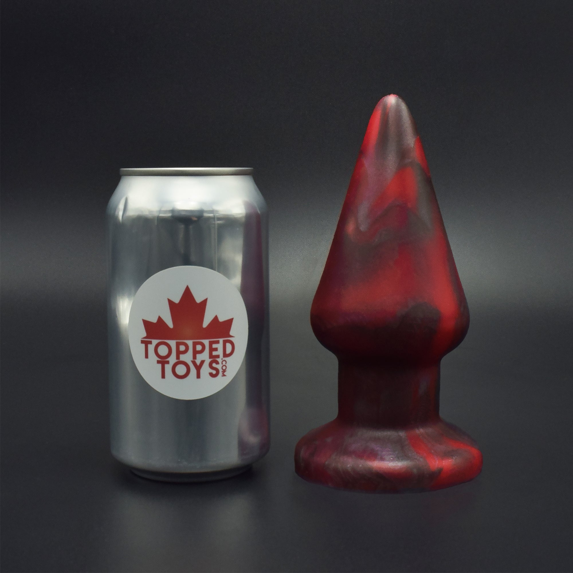 Grip 80 in Forge Red, next to pop can with Topped Toys logo