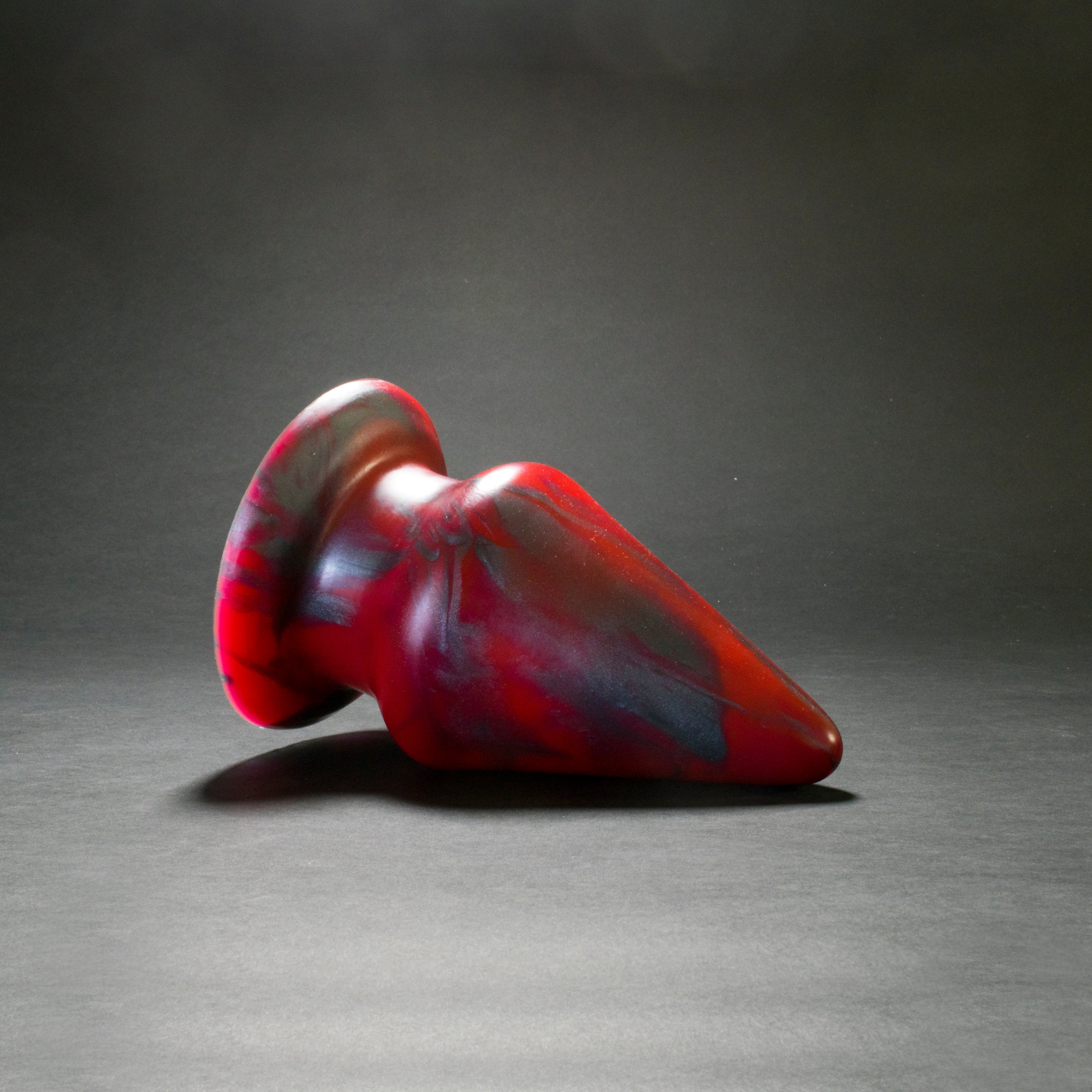 Grip 134 in Forge Red laying on its side