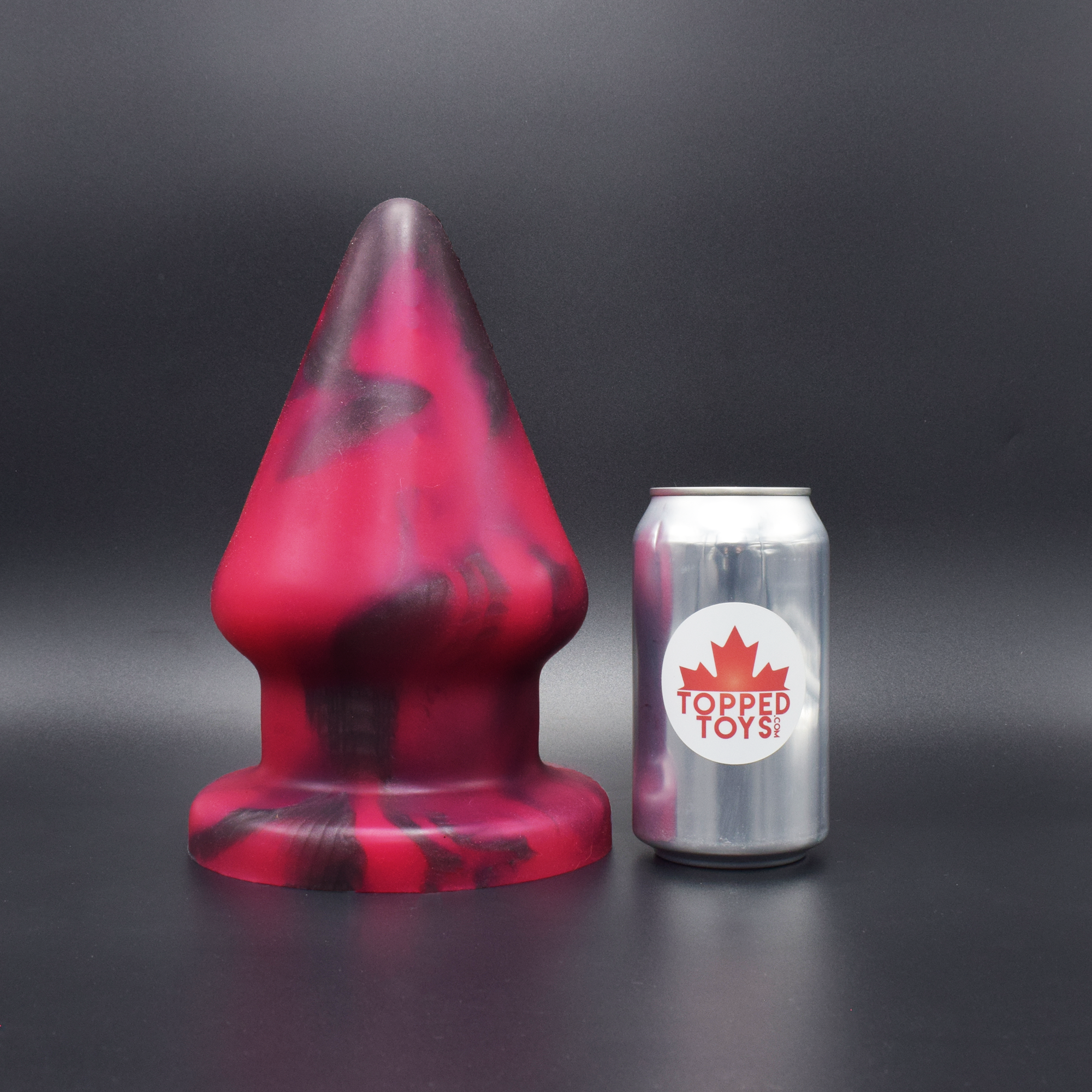 Grip 160 in Forge Red, next to pop can with Topped Toys logo
