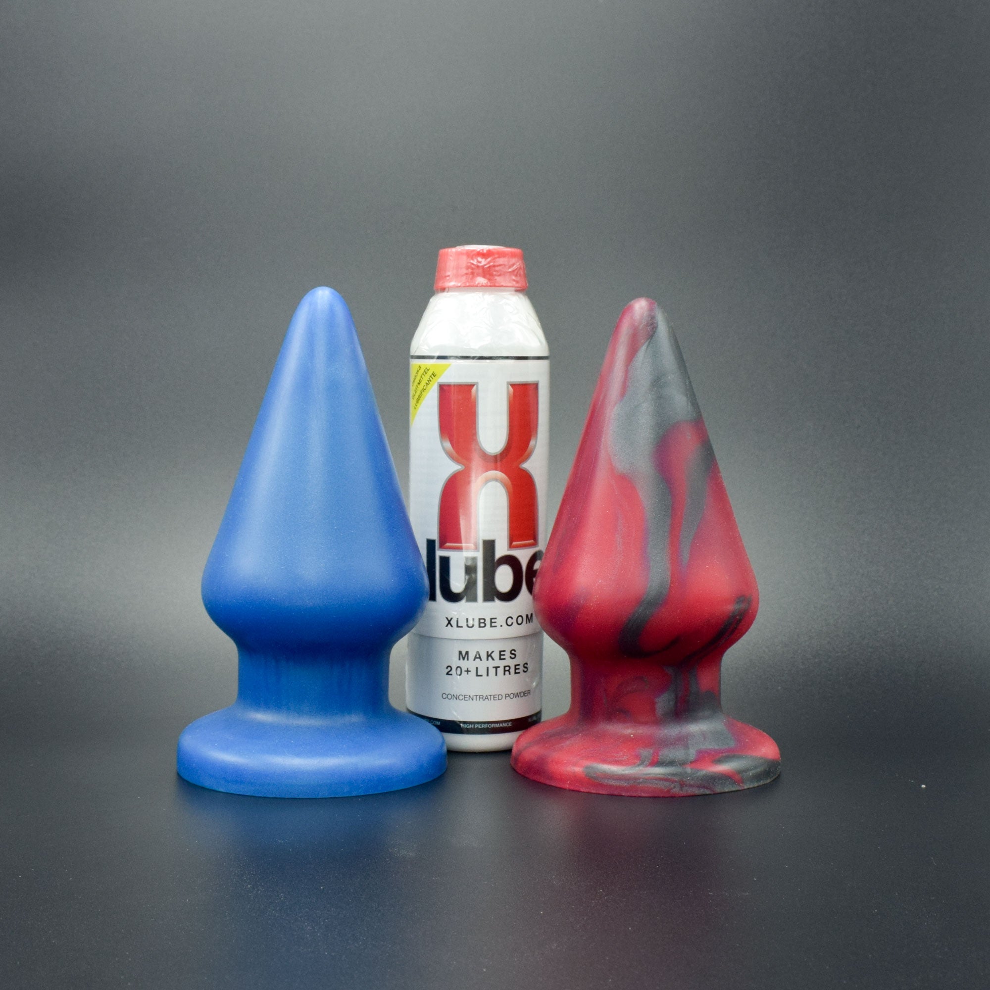Grip 96 in Blue Steel and Forge Red, next to bottle of X-Lube for scale