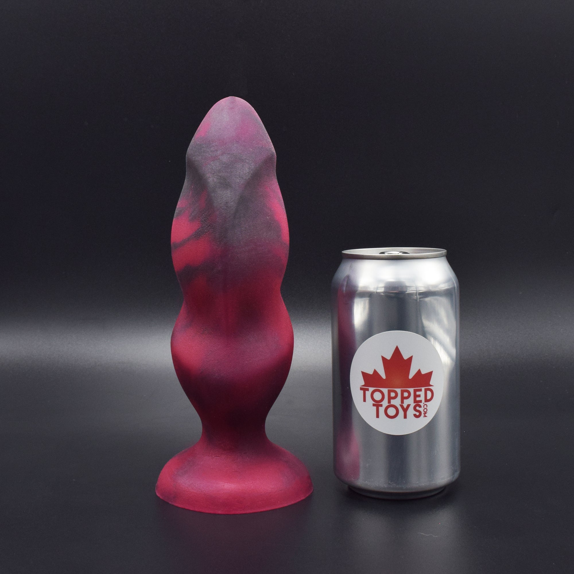 Hilt 75 in Forge Red facing forward to show detail to show detail, next to pop can with Topped Toys logo