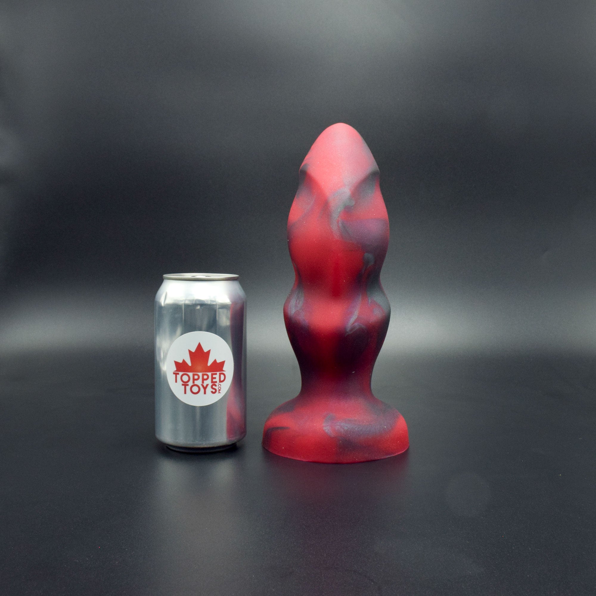 Hilt 95 in Forge Red facing forward to show detail, next to pop can with Topped Toys logo