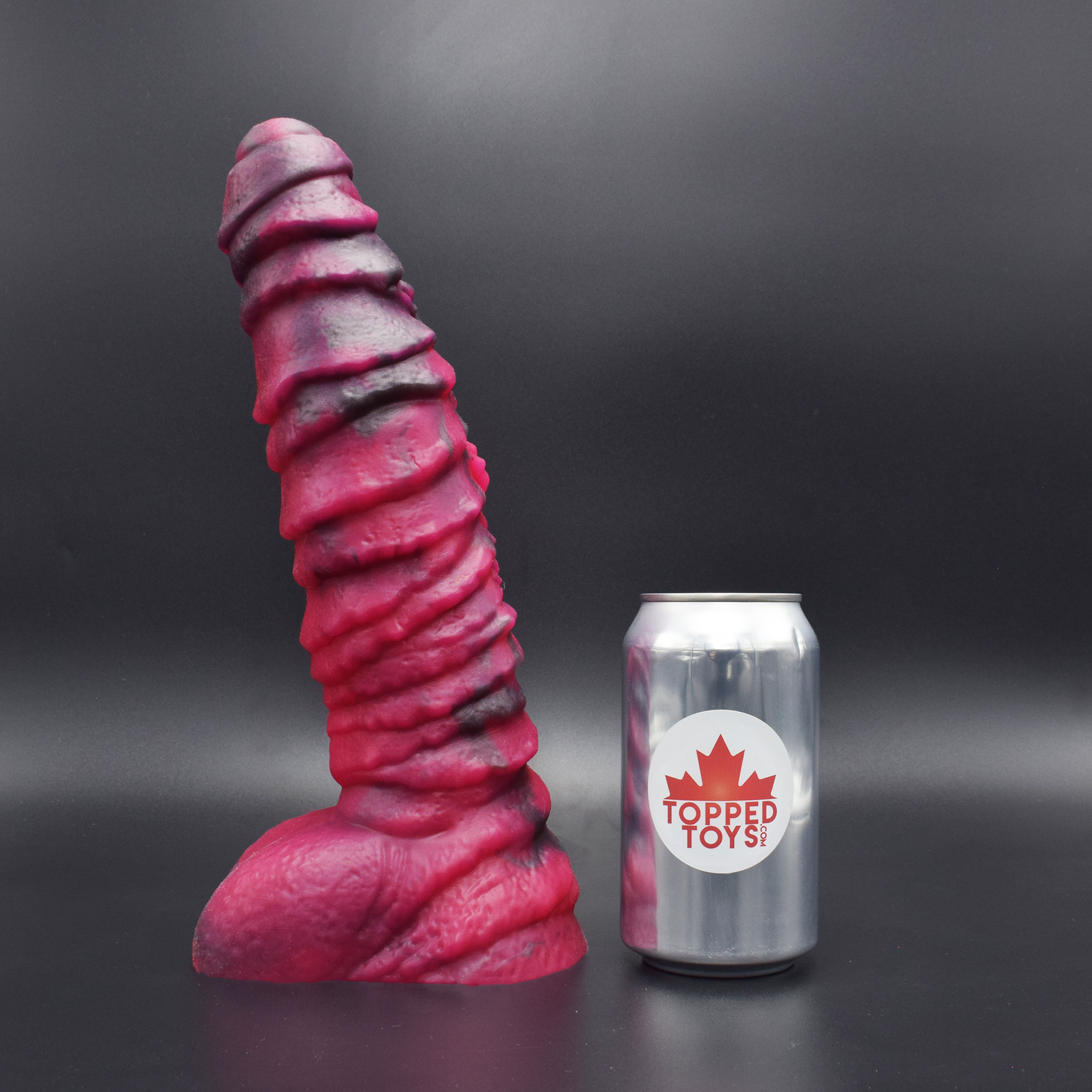 Mordax 90 in Forge Red facing left to show detail, next to pop can with Topped Toys logo