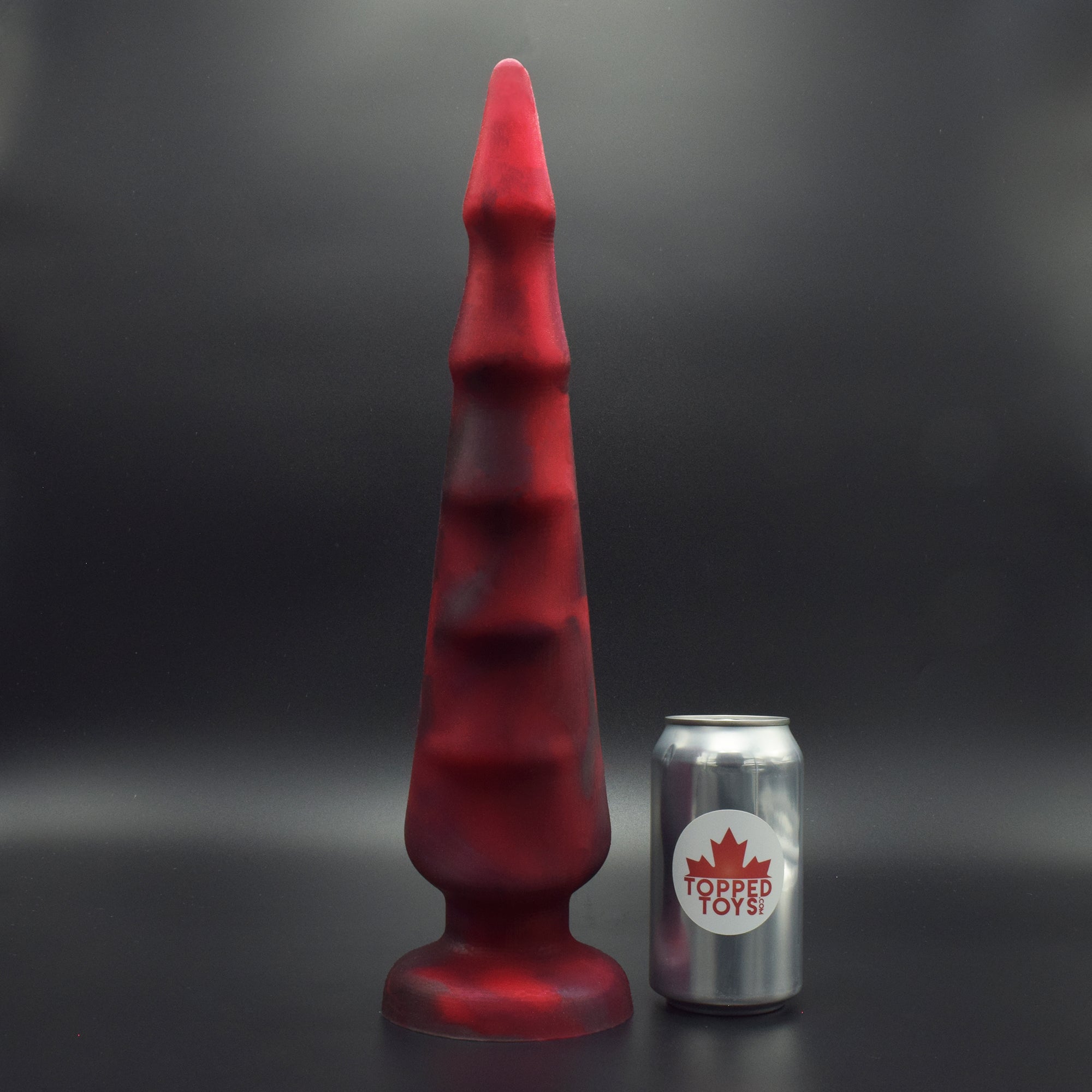 Spike 105 in Forge Red, next to pop can with Topped Toys logo