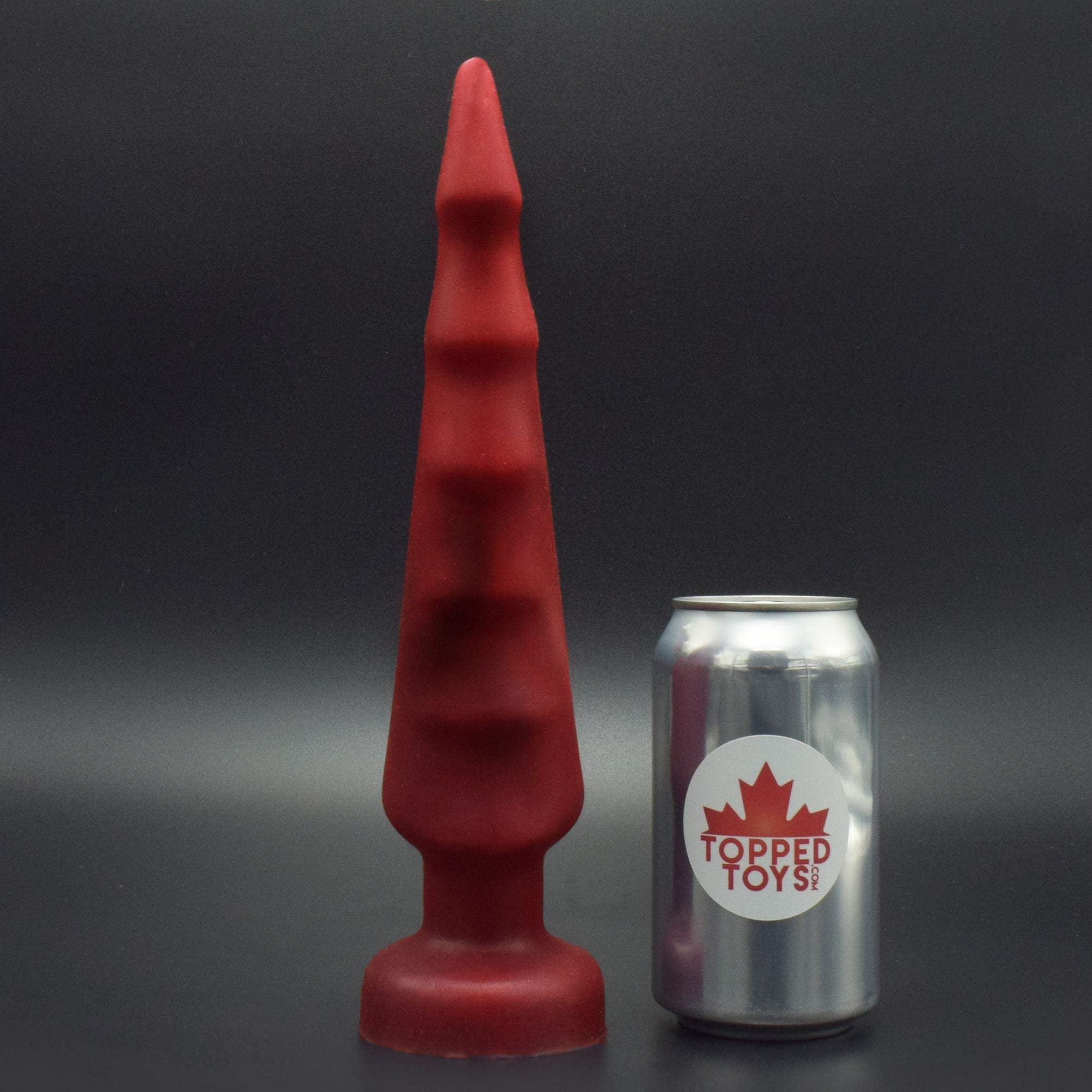 Spike 70 in Forge Red, next to pop can with Topped Toys logo