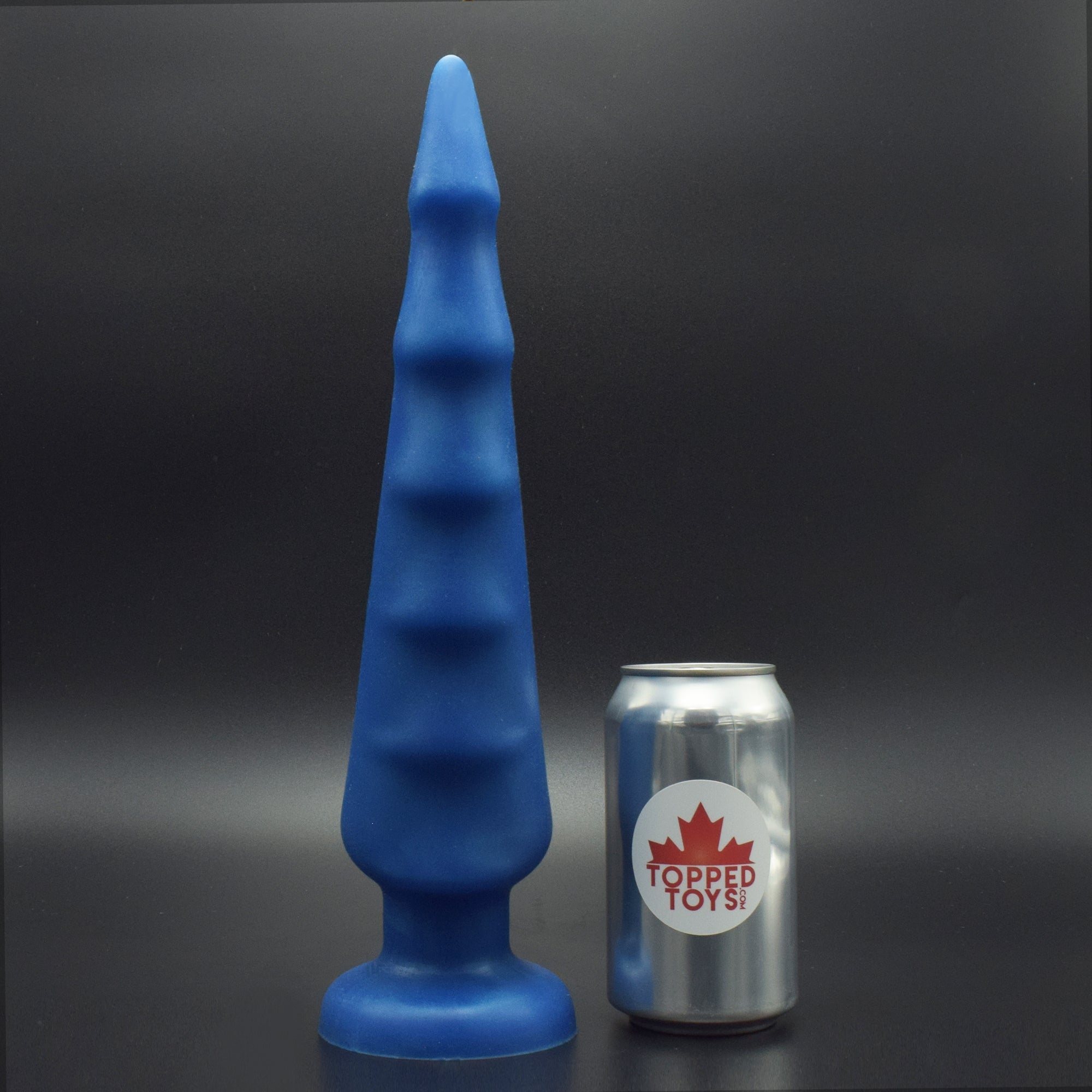 Spike 90 in Blue Steel, next to pop can with Topped Toys logo