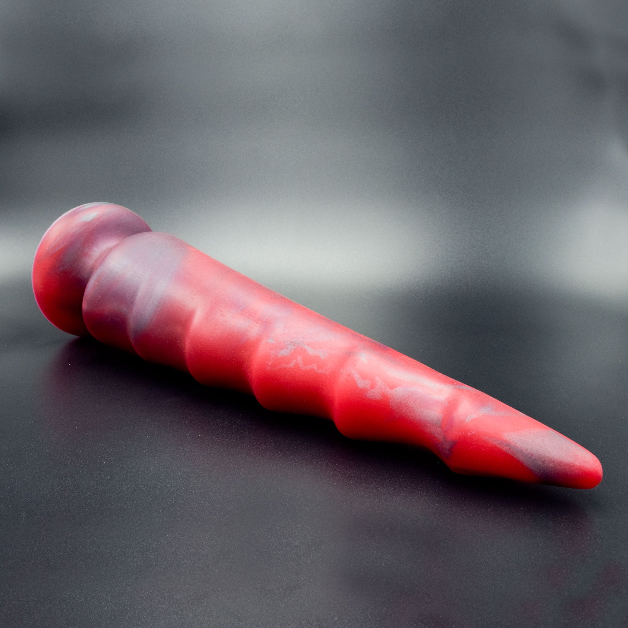 Spike 125 in Forge Red laying on its side