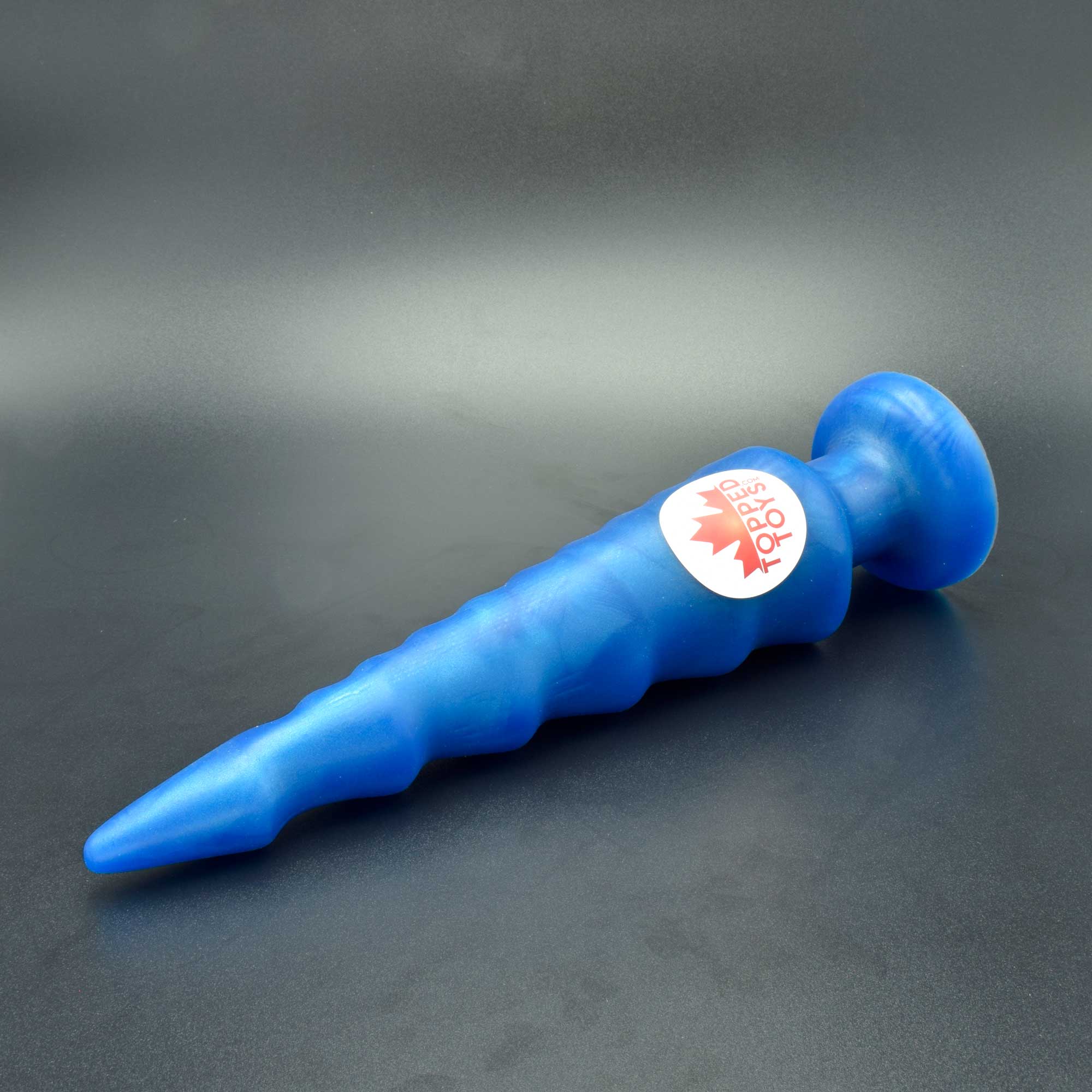 Spike 90 in Blue Steel laying on its side, with Topped Toys sticker