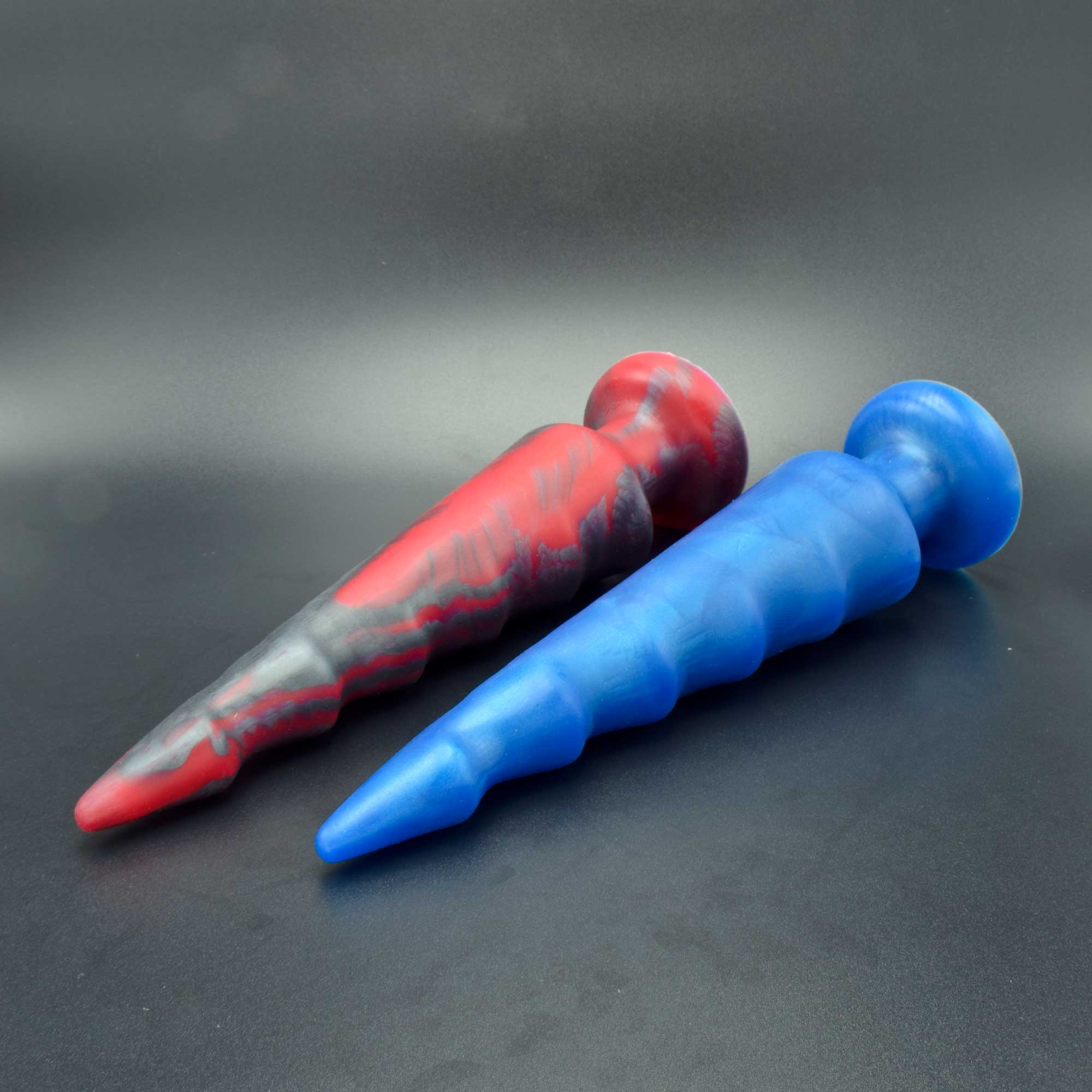 Spike 90 in Forge Red and Blue Steel laying on their sides