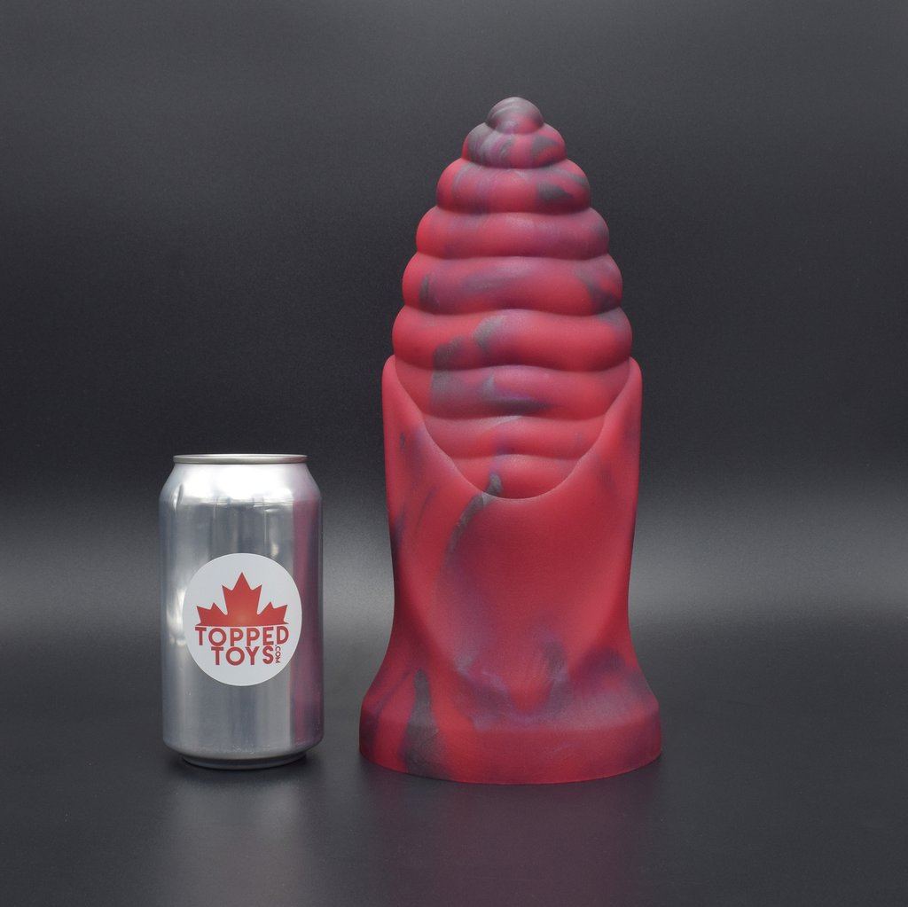 Cetos 130 in Forge Red facing forwards, next to pop can with Topped Toys Logo
