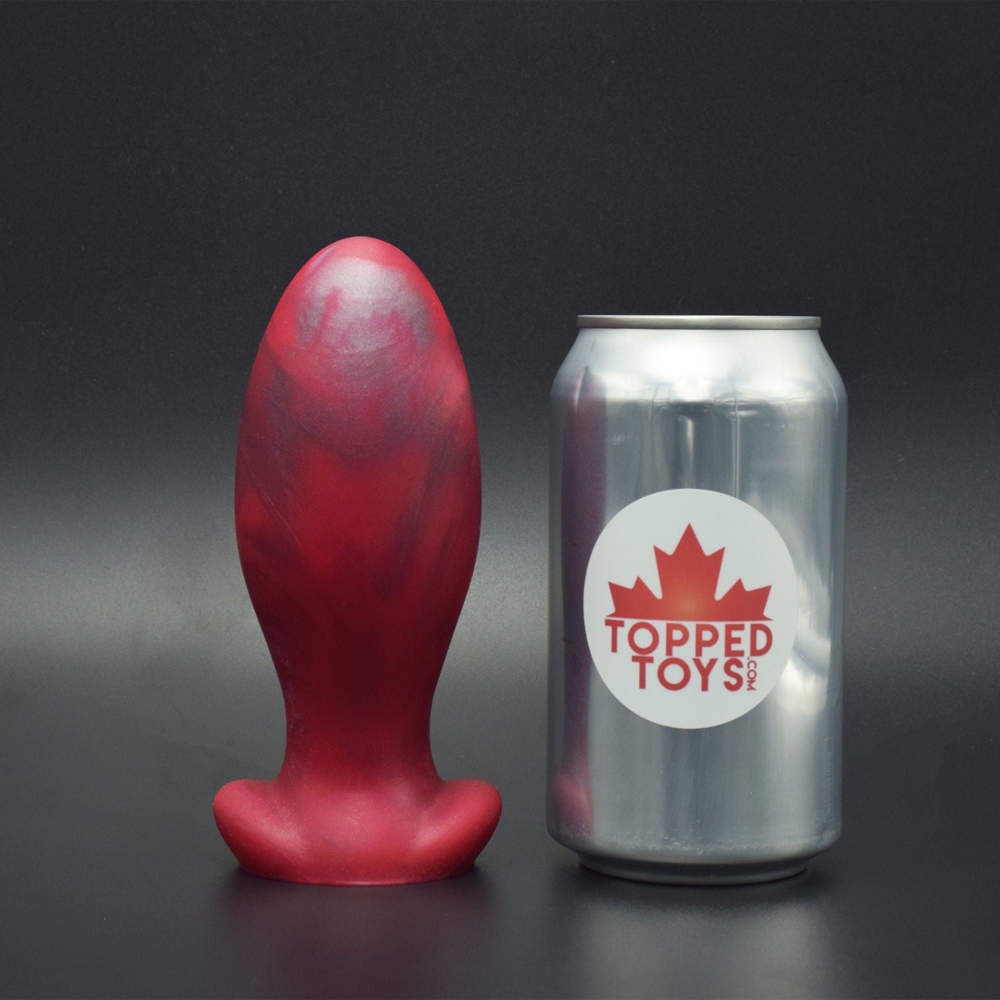 Gape Keeper 65 in Forge Red, next to pop can with Topped Toys logo