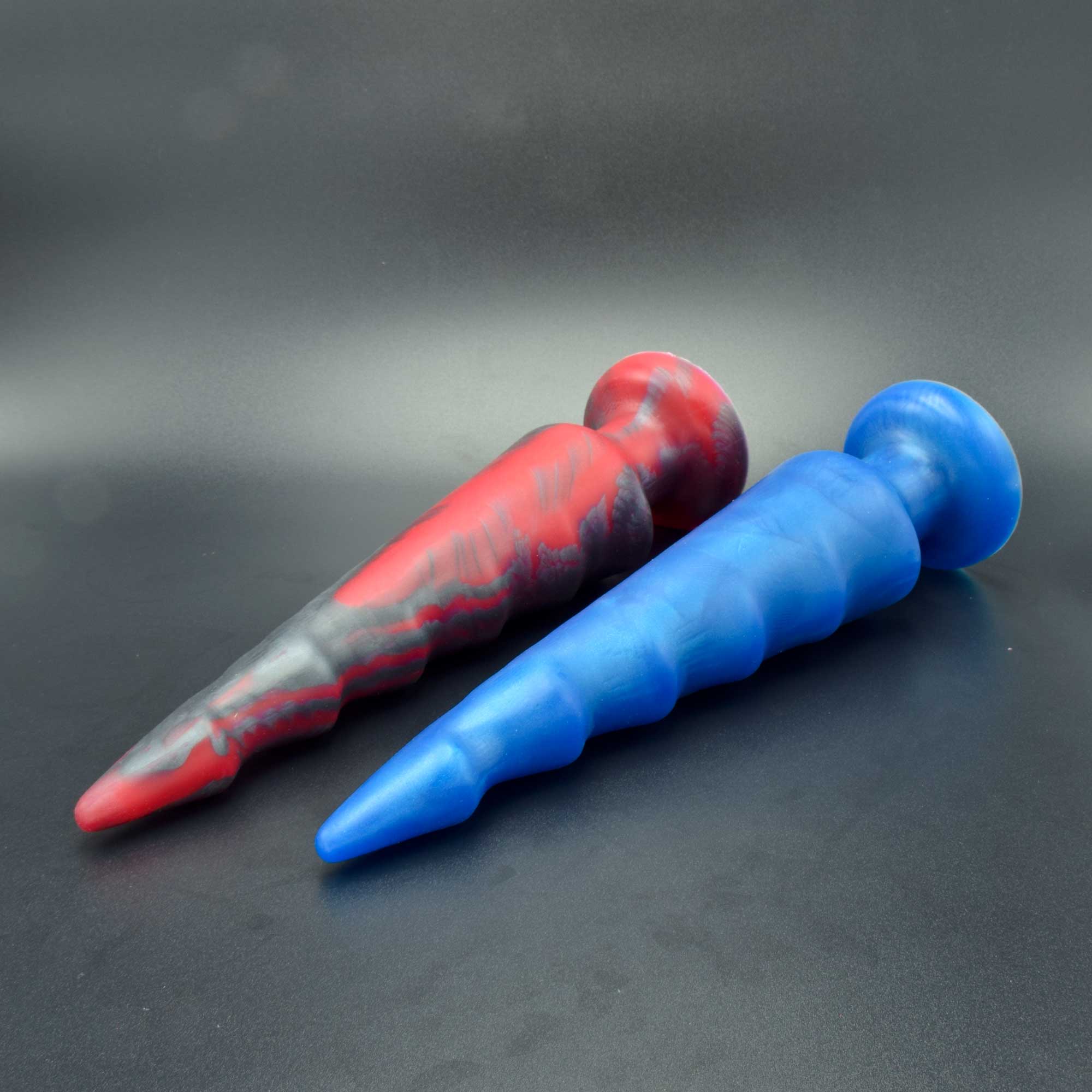 Spike 90 in Forge Red and Blue Steel laying on their sides 